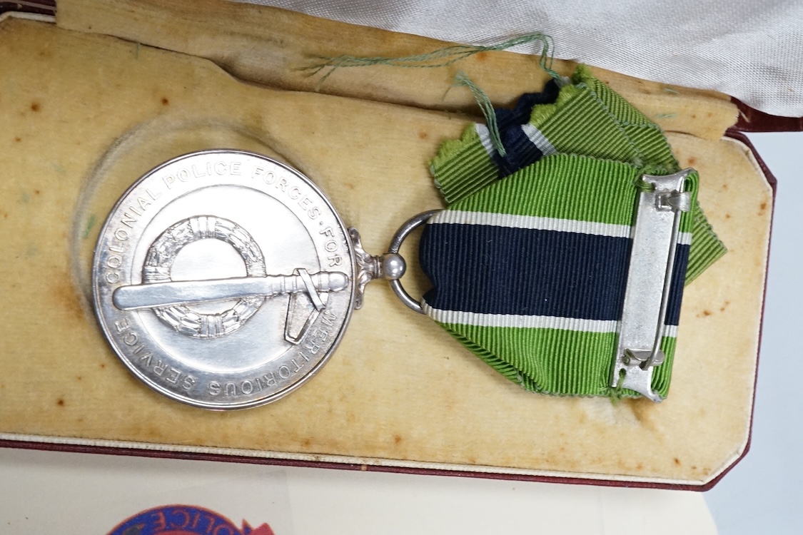 A cased ERII Colonial Police Force Medal for Meritorious Service awarded to John F. Brown, Asst. Supt. Kenya Police., together with a WWII miniature medal set including a General Service Medal with a clasp for Palestine